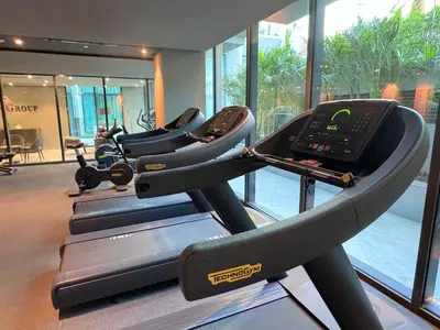 a row of treadmills in a gym at Luxury Studio with Balcony, Pool, Coworking in JVC in Dubai