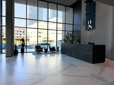 a lobby with a reception desk in a building at Luxury Studio with Balcony, Pool, Coworking in JVC in Dubai