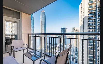a balcony with chairs and a table and a view of a city at Luxury 1025 sq feet 1 bed apartment in 29 floor Dubai Creek Residences in Dubai