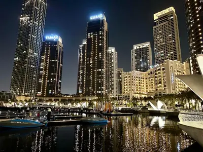 a view of a city at night with boats in the water at Luxury 1025 sq feet 1 bed apartment in 29 floor Dubai Creek Residences in Dubai