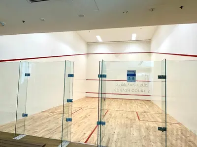 a gymnasium with a basketball court with a glass wall at Luxury 1025 sq feet 1 bed apartment in 29 floor Dubai Creek Residences in Dubai