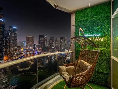 a balcony with chairs and a view of a city at Luxury Waterfront View w Ain Dubai and PS5 in JBR 5 min from the beach in Dubai