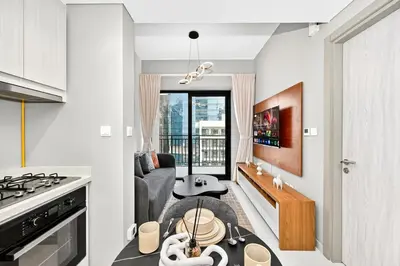 a living room with a couch and a table at Golden Stays - Cozy 1BR Retreat I Skyline Views & Urban Charm in Dubai