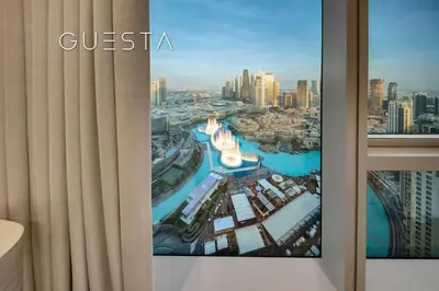 a view of a city from a window at Grande Tower by Emaar - Burj Khalifa and Fountain Views, Downtown Dubai in Dubai