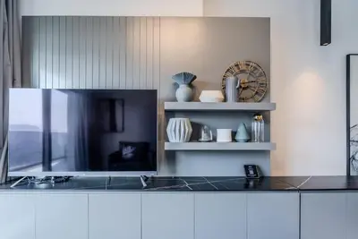 a kitchen with a counter and a clock on the wall at TRPS - MAG 318, Business Bay - Spacious 1BR plus Maids, Furnished, City View in Dubai