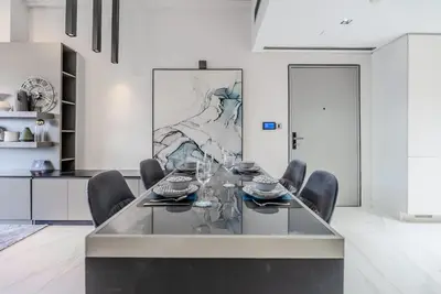 a dining room with a glass table and chairs at TRPS - MAG 318, Business Bay - Spacious 1BR plus Maids, Furnished, City View in Dubai