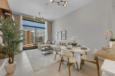 a living room with a table and a couch at Lux 1 Bedroom Apartment in Majan in Dubai