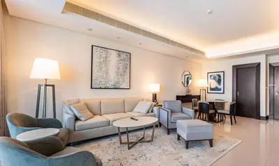 a living room with a couch and chairs and a table at Dubai Mall 5 star Free Parking in Dubai