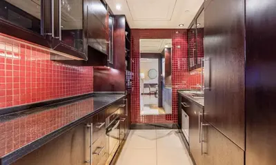 a kitchen with red tiles on the walls and counters at Dubai Mall 5 star Free Parking in Dubai