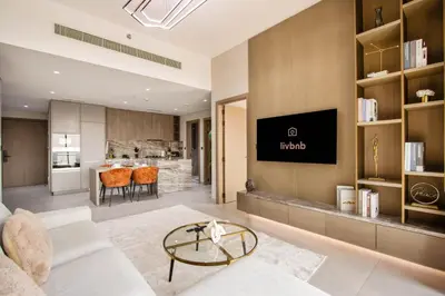 a living room with a couch and a table at Luxury 1BR High Floor Rooftop Pool Access in Dubai