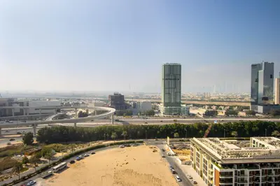 a view of a city with a beach and buildings at Luxury 1BR High Floor Rooftop Pool Access in Dubai