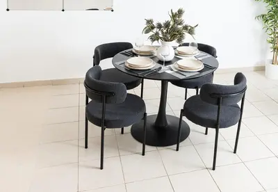 a black dining room table with black chairs and plates at Stunning 1 Bed in Al Dhafra 2 The Greens in Dubai