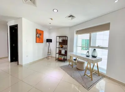 a living room with a table and a window at Luxury Marina Views Near Mall & Beach, with Gym, Swimming Pool & Car Park in Dubai