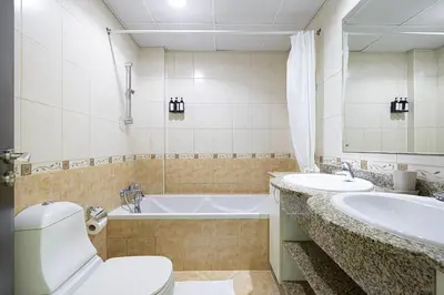 a bathroom with a tub and a toilet and a sink at Luxury Marina Views Near Mall & Beach, with Gym, Swimming Pool & Car Park in Dubai