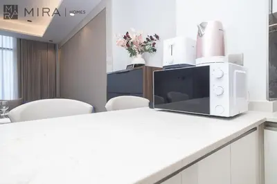a microwave sitting on top of a kitchen counter at Mira Holiday Homes - High View 2 Bed Oasis at Nobles Tower with Sauna in Dubai