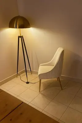 a chair sitting next to a lamp in a room at TravelTime Marina in Dubai