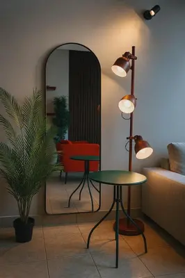 a living room with a table and a mirror at TravelTime Marina in Dubai
