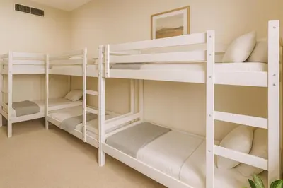 a room with white bunk beds in a room at TravelTime Marina in Dubai