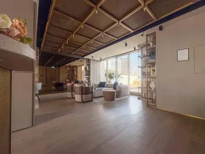 a living room with chairs and tables in a building at Frank Porter - Pearl House in Dubai