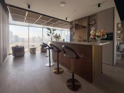 a kitchen with a bar with a view of the city at Frank Porter - Pearl House in Dubai