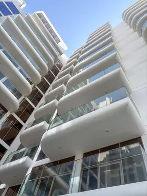 a tall white building with a lot of windows at Frank Porter - Pearl House in Dubai