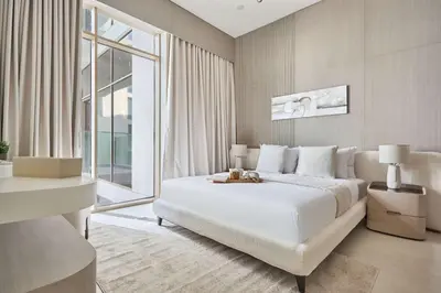 a bedroom with a large white bed and a window at Frank Porter - Pearl House in Dubai