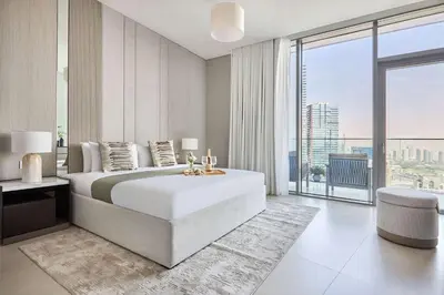 a bedroom with a large bed and a large window at Frank Porter - Liv Marina in Dubai