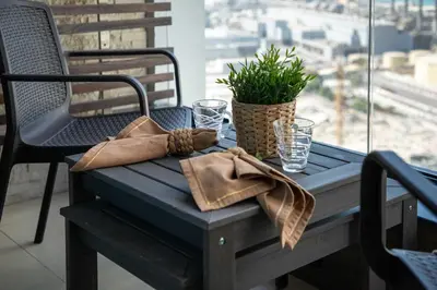 a blue table with a bag and glasses on it at Frank Porter - Dec Towers 1 in Dubai