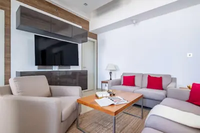 a living room with two couches and a tv at Frank Porter - Dec Towers 1 in Dubai