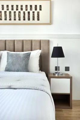 a bedroom with a bed and a table with a lamp at Frank Porter - Marina Diamond 4 in Dubai
