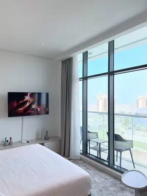 a bedroom with a bed and a large window at Séjour raffiné et inoubliable in Dubai