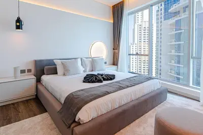 a bedroom with a large bed with a large window at 2 BR Superb and Luxury Dubai Marina View in Dubai