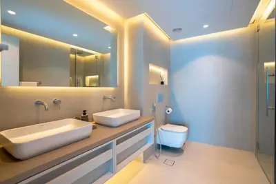 a bathroom with two sinks and a toilet in it at 2 BR Superb and Luxury Dubai Marina View in Dubai