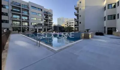 a swimming pool in the middle of a building at Cozy & Bright 1BR La Riviera Estate A in Dubai
