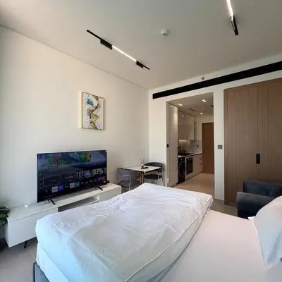 a bedroom with a bed and a flat screen tv at A place like home for relaxation in Dubai