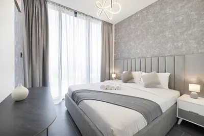 a bedroom with a large bed and a large window at Luxurious Crest Tower Suites By Hostiva- Burj View in Dubai