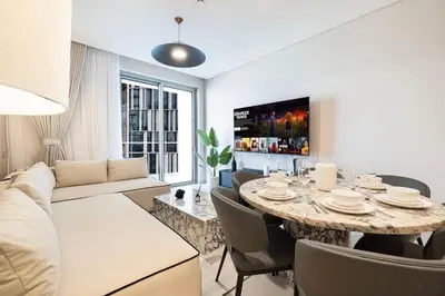 a living room with a table and a couch at 2BR Vida Dubai Mall Tower 2 Direct Mall Access in Dubai