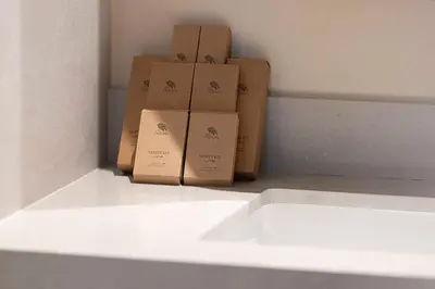 three boxes sitting on a shelf in a room at 2BR Vida Dubai Mall Tower 2 Direct Mall Access in Dubai