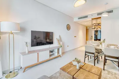 a living room with a tv and a table at PVH - Downtown Magnificent 2BR - Vida Dubai Mall in Dubai