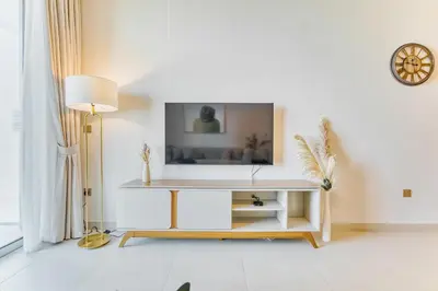 a white living room with a table and a lamp at PVH - Downtown Magnificent 2BR - Vida Dubai Mall in Dubai