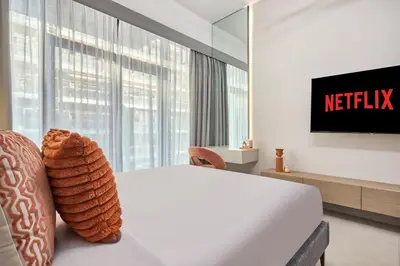 a hotel room with a bed and a tv at Elegant Luxury Studio 12th Floor Sky high View in Dubai