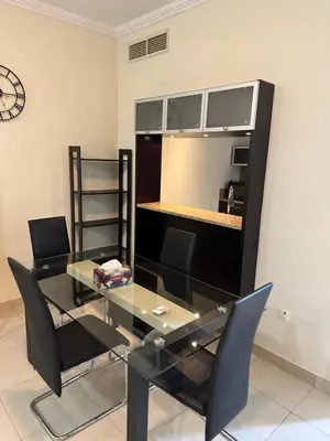 a dining room with a glass table and black chairs at Fantastic 1 bed apt near Marina & Jumeira Beach in Dubai