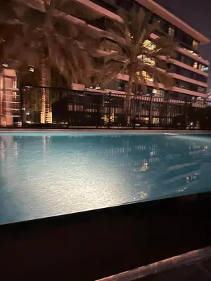 a large swimming pool in front of a building at Fantastic 1 bed apt near Marina & Jumeira Beach in Dubai