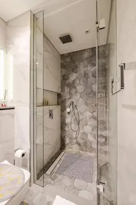 a bathroom with a shower with a glass door at Minutes Walk To Dubai Mall Studio With All Comfort in Dubai