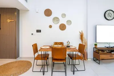 a dining room with a wooden table and chairs at 1-Bedroom Apartment near Dubai Frame High Floor in Dubai
