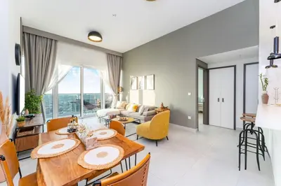 a dining room and living room with a table and chairs at 1-Bedroom Apartment near Dubai Frame High Floor in Dubai