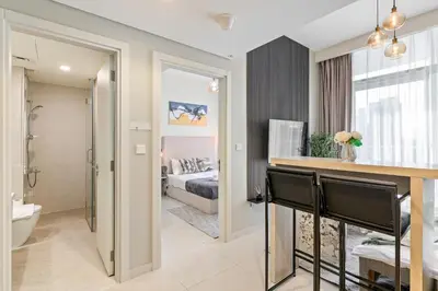 a bathroom and a bedroom with a bed and a tub at Burj Khalifa&City View 1BR, Near Dubai Water Canal, Vera Tower, Business Bay by Morada Holidays in Dubai