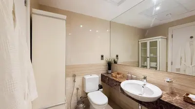 a bathroom with a sink and a toilet and a mirror at TRIDENT GRAND JBR I BEACHFRONT 2-Bedroom Apartment I Beautiful Palm and Ocean Views I Amazing Balcony Space in Dubai