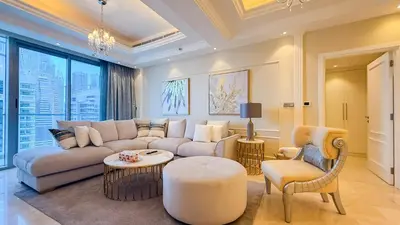 a living room with a couch and a table and chairs at TRIDENT GRAND JBR I BEACHFRONT 2-Bedroom Apartment I Beautiful Palm and Ocean Views I Amazing Balcony Space in Dubai