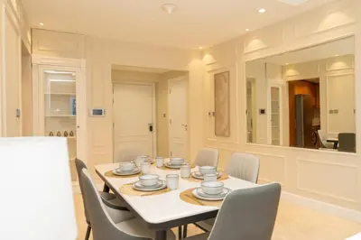 a dining room with a table and chairs and a mirror at TRIDENT GRAND JBR I BEACHFRONT 2-Bedroom Apartment I Beautiful Palm and Ocean Views I Amazing Balcony Space in Dubai